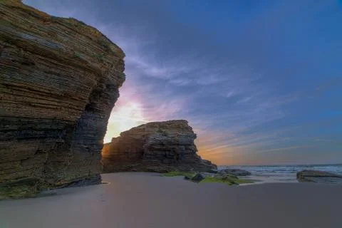 Sunrise between slate Cliffs on the Coast Stock Photos