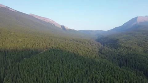 Sunrise Casting Light and Shadow in a Mountain Valley Stock Footage 318818027