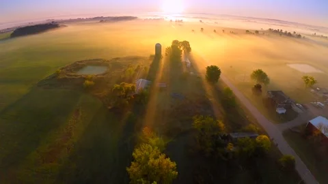 Sunrise casts long shadows across misty scenic landscape Stock Footage 300601939