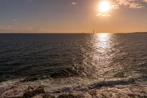 Sunrise from a cliff with moving clouds in a different direction forming a li Foto stock