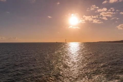 Sunrise from a cliff with moving clouds in a different direction forming a li Stock-Fotos