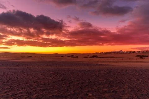 Sunrise from a cliff with moving clouds in a different direction forming a li Stock-Fotos