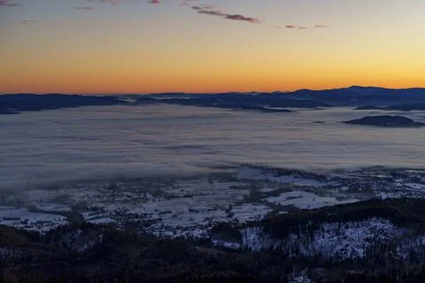 Sunrise cloud inversion over valley town and mountains Stock Photos