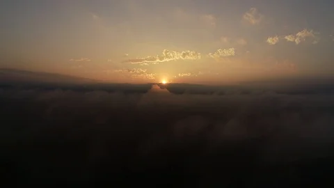 Sunrise in the clouds over Mountains Stock Footage 128846205