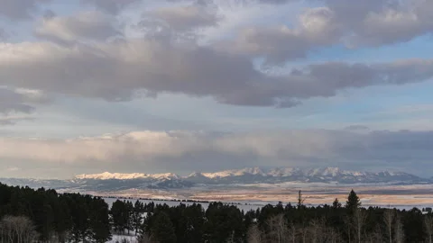 Sunrise clouds over valley distant mountains Bridger Mountains Stock Footage 167046463