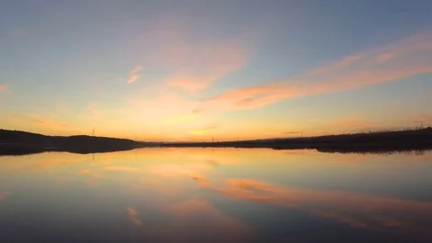 Sunrise with clouds reflection in lake Stock Footage 83906352