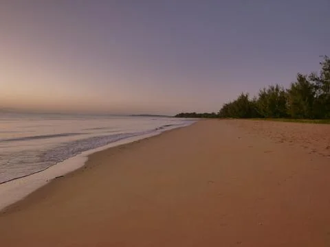 Sunrise on coloured beach Stock Photos