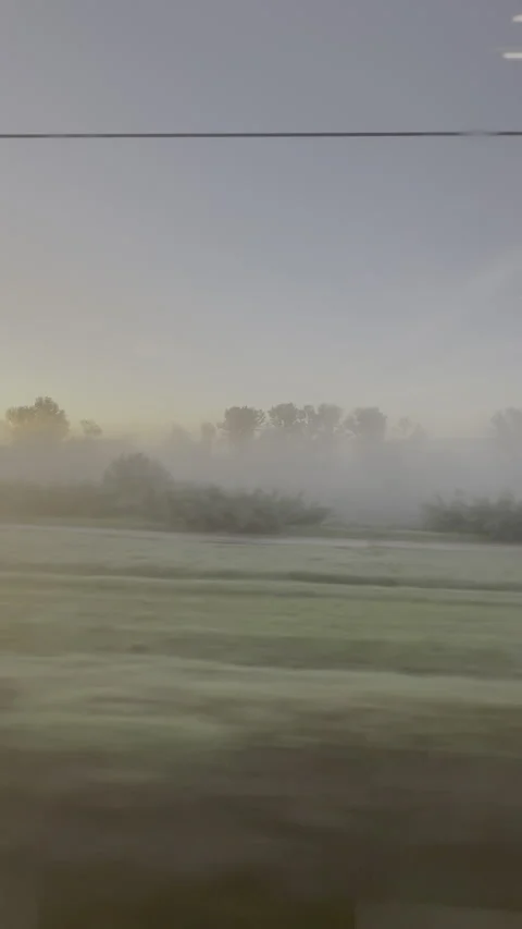Sunrise countryside rushing by from a train window Stock Footage 327140209