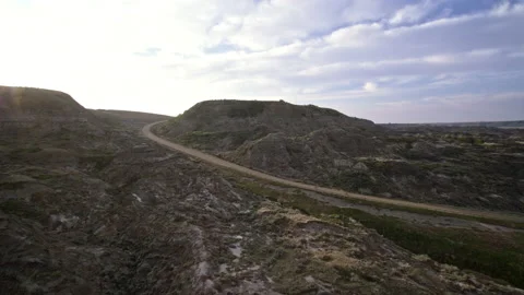Sunrise cyclist fly down hill drone shot Stock Footage 172250642