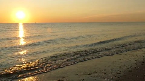 Sunrise at Delaware Bay, Waves, LR pan to empty pebbled beach, 4K Stock Footage 139018002