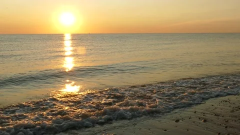 Sunrise at Delaware Bay, Waves, LR pan slower to empty pebbled beach, 4K Stock Footage 139018155