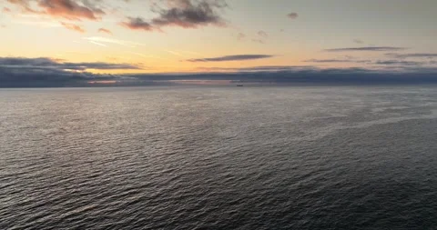 Sunrise with distant cargo ship on the horizon Stock Footage 339670073
