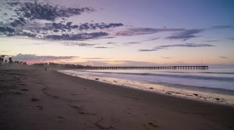 Sunrise dolly time lapse on beach shore with distant pier Video stock 43014921