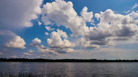 Sunrise with dramatic cloudscape over the sea video. Lake under blue sky. Stock Footage 136221538