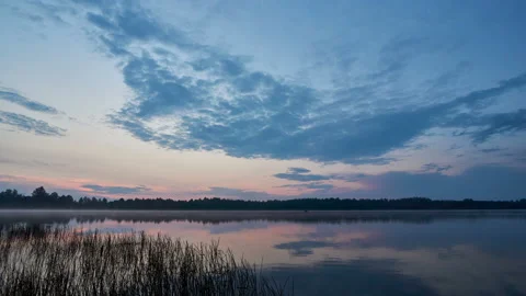 Sunrise with dramatic cloudscape over the sea video. Lake under blue sky. Stock Footage 136221857