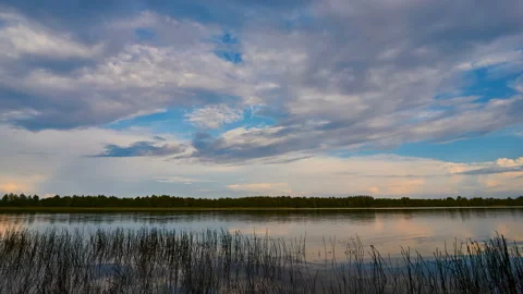 Sunrise with dramatic cloudscape over the sea video. Lake under blue sky. Stock Footage 136222179