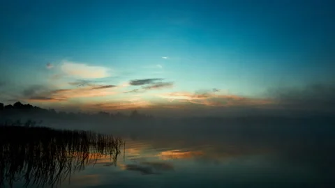 Sunrise with dramatic cloudscape over the sea video. Lake under blue sky. Stock Footage 136222536
