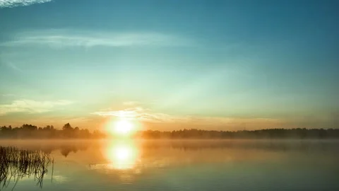 Sunrise with dramatic cloudscape over the sea video. Lake under blue sky. Stock Footage 136222747