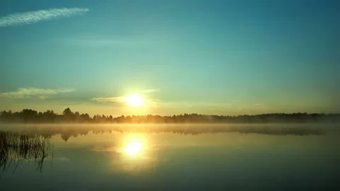 Sunrise with dramatic cloudscape over the sea video. Lake under blue sky. Stock Footage 136223187