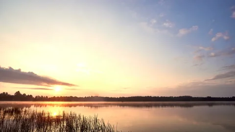 Sunrise with dramatic cloudscape over the sea video. Lake under blue sky. Stock Footage 136226247