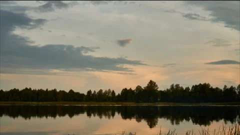 Sunrise with dramatic cloudscape over the sea video. Lake under blue sky. Stock Footage 136227368