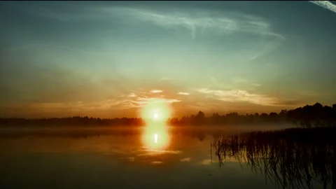 Sunrise with dramatic cloudscape over the sea video. Lake under blue sky. Stock Footage 136455592