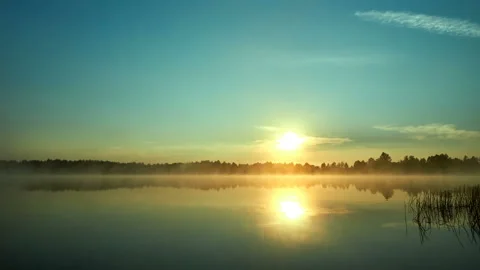 Sunrise with dramatic cloudscape over the sea video. Lake under blue sky. Stock Footage 136455890