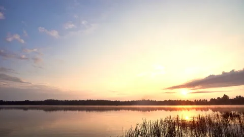 Sunrise with dramatic cloudscape over the sea video. Lake under blue sky. Stock Footage 136458344