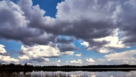 Sunrise with dramatic cloudscape over the sea video. Lake under blue sky. Stock Footage 136458535