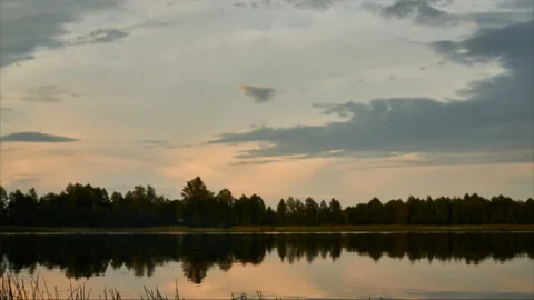 Sunrise with dramatic cloudscape over the sea video. Lake under blue sky. Stock Footage 136458807