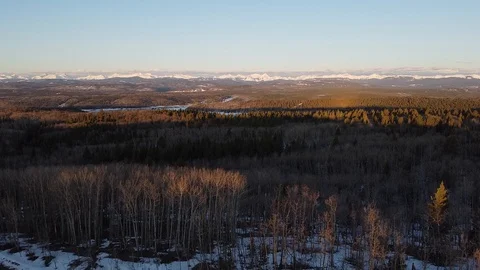 Sunrise drone over trees towards beautiful mountains Stock Footage 129049362