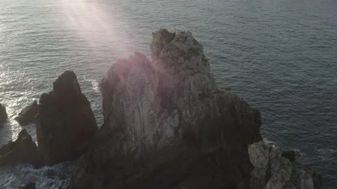 Sunrise drone point of view of big cliffs surrounded by ocean 4K in Spain Stock Footage 137707325