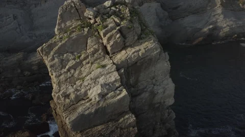 Sunrise drone point of view of big cliffs surrounded by ocean 4K in Spain Stock Footage 137707399