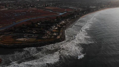 Sunrise Drone Pull Back From Ocean Point Pan to Sky 库存影片 100656561
