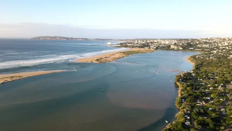 Sunrise drone pullback over Keurbooms river lagoon mouth and Plettenberg Bay Stock Footage 333381314