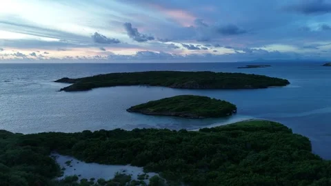 Sunrise drone view of Cap Chevalier islets, Martinique - misty clouds 4K Stock Footage 306953573
