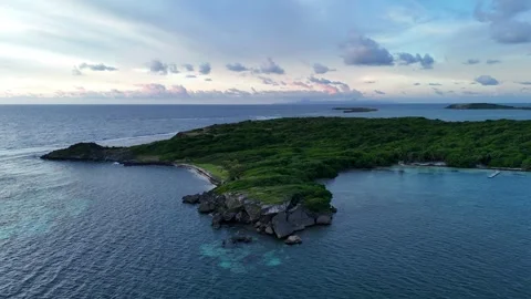 Sunrise drone view of Cap Chevalier islets, Martinique - misty clouds 4K Stock Footage 306953619