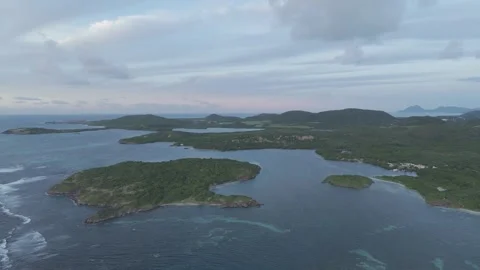 Sunrise drone view of Cap Chevalier islets, Martinique - misty clouds 4K Stock Footage 306953640
