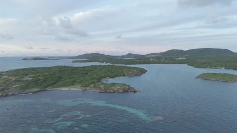 Sunrise drone view of Cap Chevalier islets, Martinique - misty clouds 4K Stock Footage 306953653