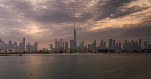 Sunrise in Dubai timelapse or hyperlapse view from boat or sea. Cloudy grey dawn Видео 129579664