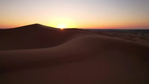 Sunrise emerging behind dunes of the Erg Chebbi sand sea near Merzouga Morocco Stock Footage 338168777