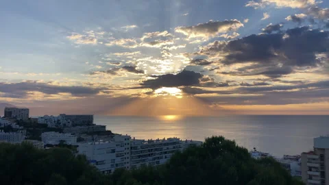 Sunrise emerging through clouds above the Mediterranean Sea Stock Footage 340479598