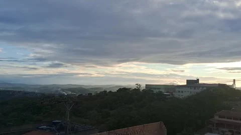 Sunrise with Fast-Moving Clouds and Smoke-Emitting Chimney in Brazil Stockbeeldmateriaal 289822765