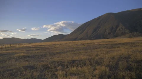 Sunrise field walk around Mount Sunday, in New Zealand Stock Footage 215349913