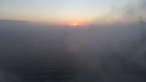 A sunrise flight through clouds over the sea, the camera captures beautiful.. Stock Footage 287135185