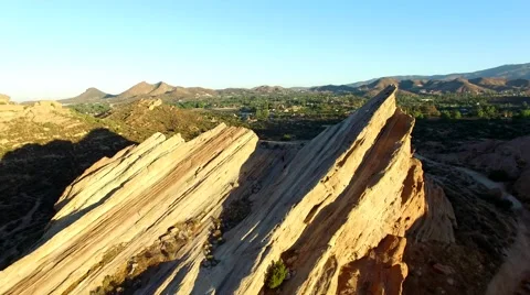 Sunrise flying between Vasquez Rocks Stock Footage 53260773