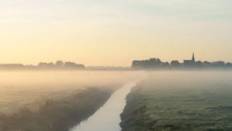 Sunrise with fog over the fields Stock Photos
