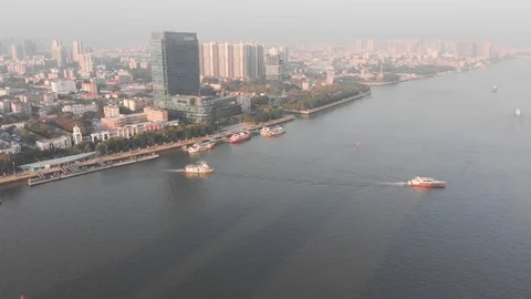 Sunrise in Guangzhou. On the river float boats. In the background is the city Stock Footage 101861006