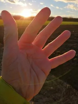 SUNRISE  with a hand Stock Photos