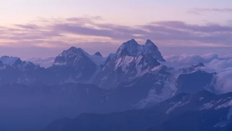 Sunrise in highest snowy mountain in floating clouds. beautiful timelapse in 4k Stock Footage 120476904